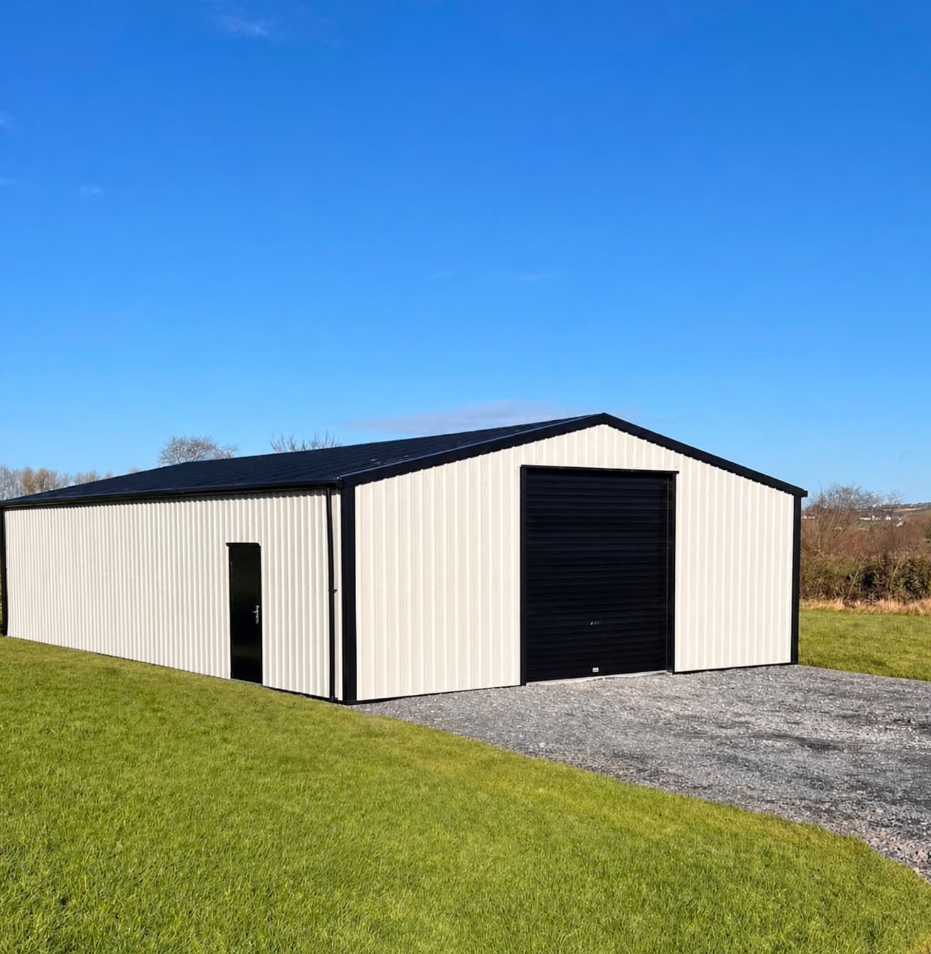 Large cream steel shed on a gravel base